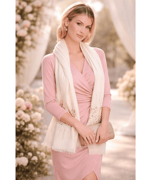 Cream oblong scarf with a cashmere-feel finish, designed for soft comfort and lightweight warmth. Features diamante embellishments and a frayed hem for a refined decorative finish. Suitable for versatile styling to elevate both casual and occasion outfits.