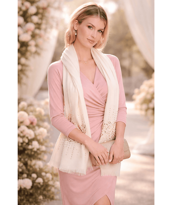 Cream oblong scarf with a cashmere-feel finish, designed for soft comfort and lightweight warmth. Features diamante embellishments and a frayed hem for a refined decorative finish. Suitable for versatile styling to elevate both casual and occasion outfits.