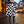 Ashlee - Avvolgimento in maglia testurizzata nera/crema con collare in finta pelliccia