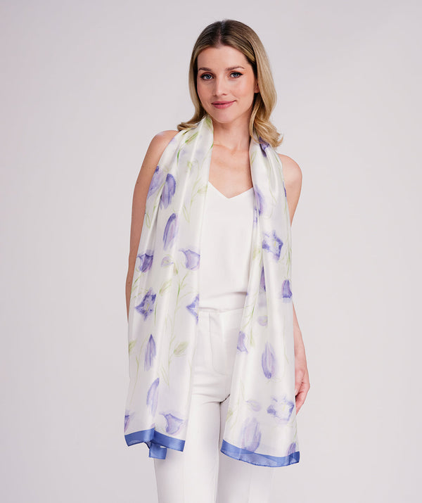 Blue oblong scarf featuring a bold abstract floral print in rich blue hues for a vibrant statement look. Made from soft, lightweight silk-feel fabric designed for a smooth drape and versatile styling.