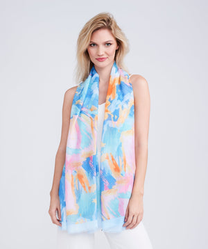 Light sky blue oblong summer scarf featuring a vibrant abstract print and finished edging for a clean, structured look. Made from soft, lightweight fabric designed for easy draping and versatile styling.