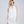 White oblong wedding scarf featuring a sheer lightweight fabric for a clean, elegant finish. Designed with subtle pearl embellishments at the ends for a refined decorative detail. Suitable for versatile draping to cover shoulders for bridal and occasion wear.