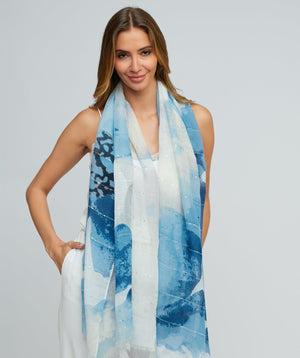 Blue oblong scarf featuring subtle shimmer detailing, embellishments, and a frayed hem for a modern textured finish. Made from lightweight fabric designed for easy draping and versatile styling.